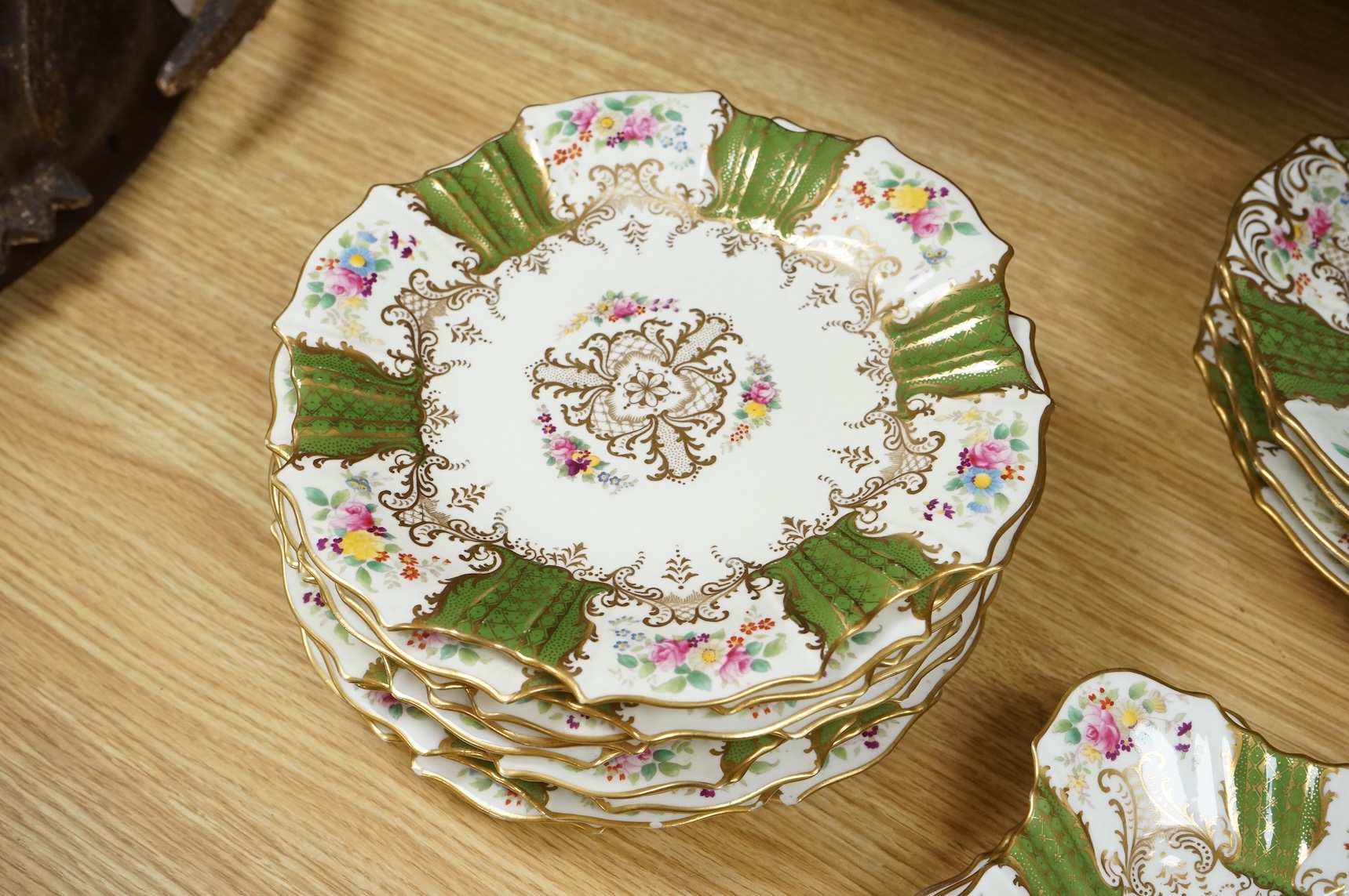 An early 20th century Wedgwood gilt and floral decorated dessert service, oval dishes 26cm wide (18).